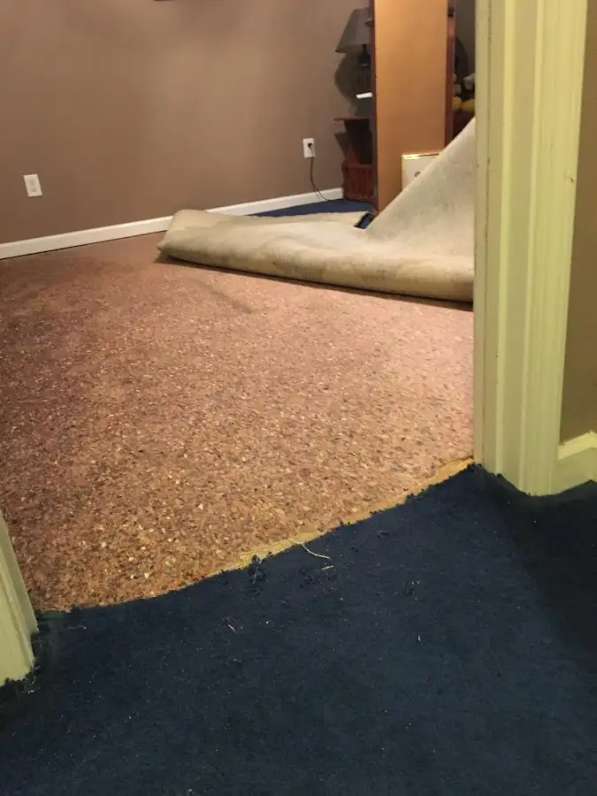 Carpet pad removal revealing water damage during Water Mitigation Services in Pryor Creek